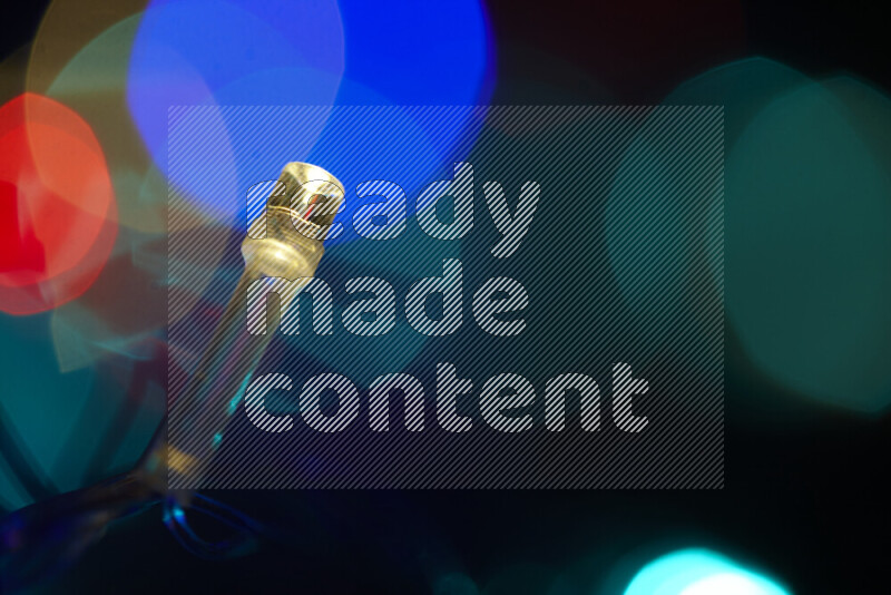 Light bulbs glowing against backdrop of multicolord bokeh