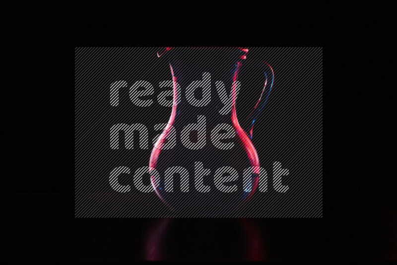 Glassware with rim light in red against black background