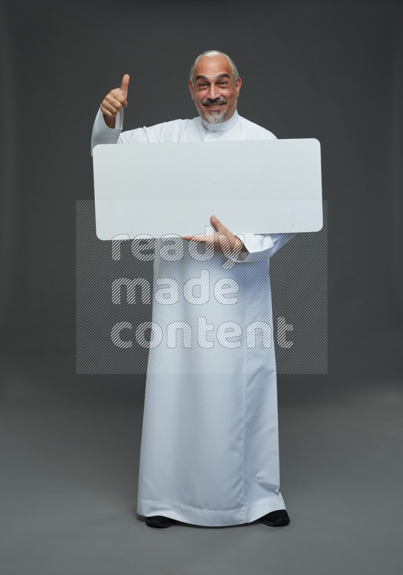 Saudi man without shomag Standing holding social media sing on gray background