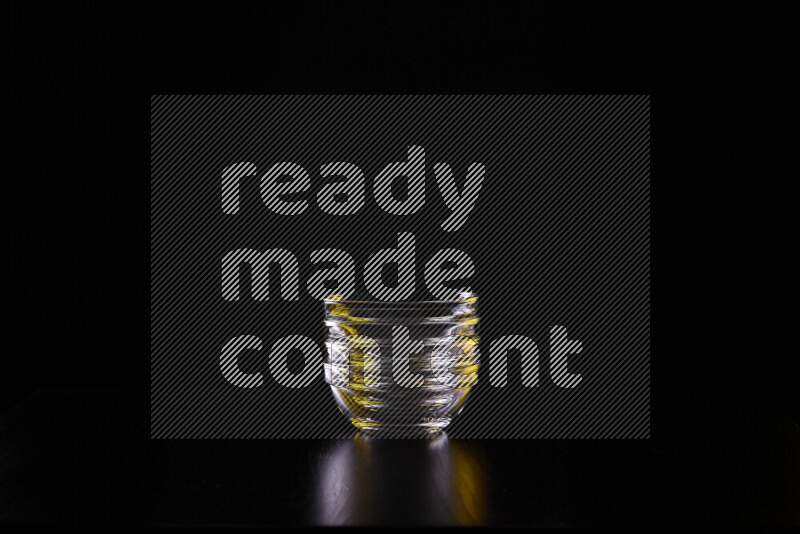 Glassware with rim light in yellow and white against black background