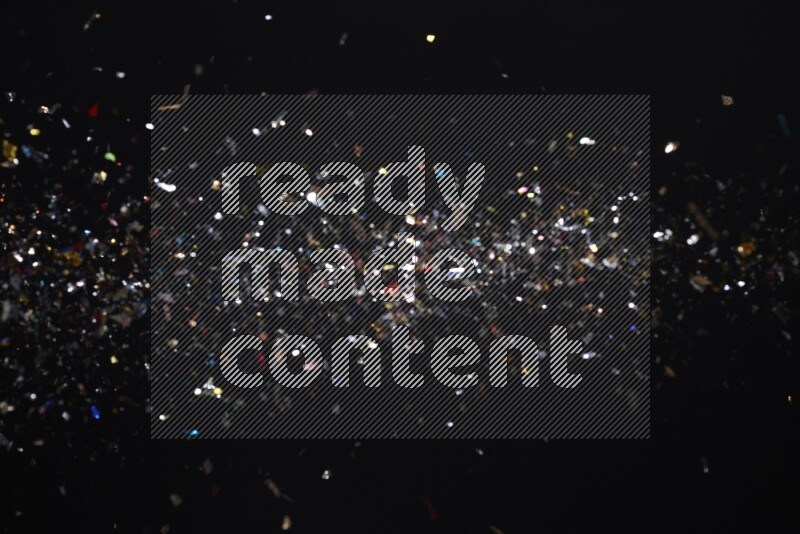 Falling multicolored confetti on black background