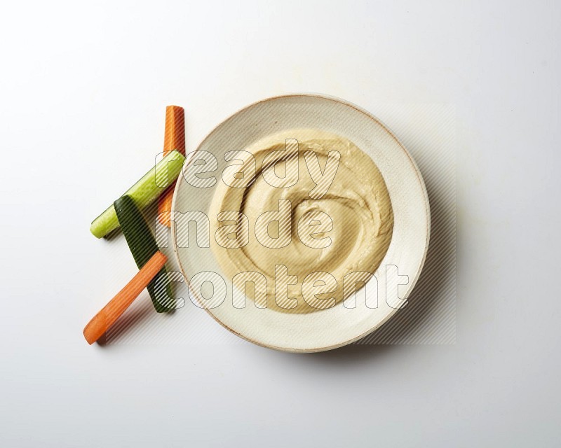 plain Hummus in a pottry plate  on a white background