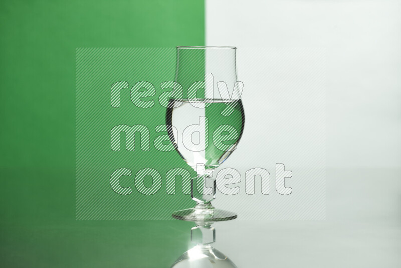 The image features a clear glassware filled with water, set against white and green background