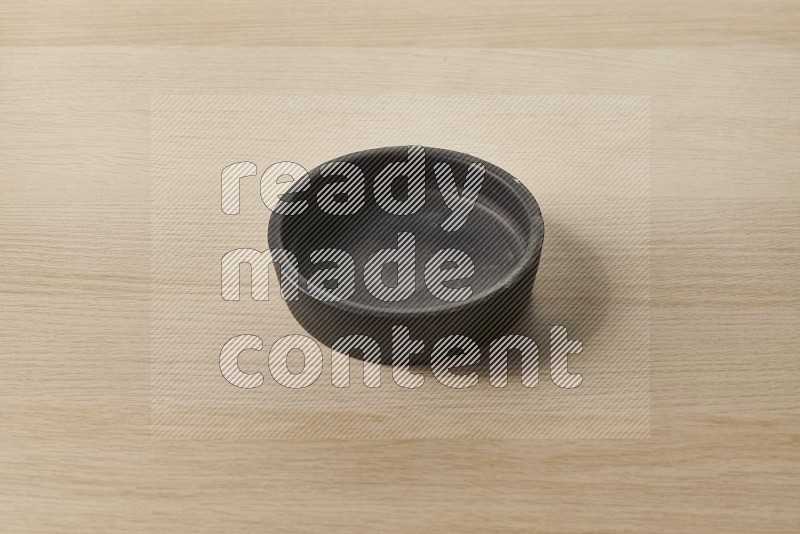 Black Pottery Bowl on Oak Wooden Flooring, 45 degrees