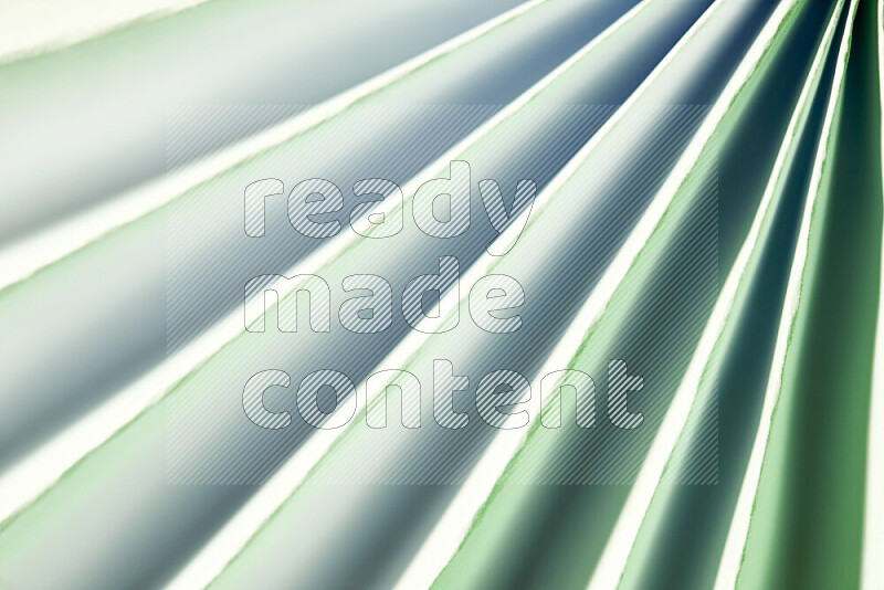 An image presenting an abstract paper pattern of lines in green and white tones