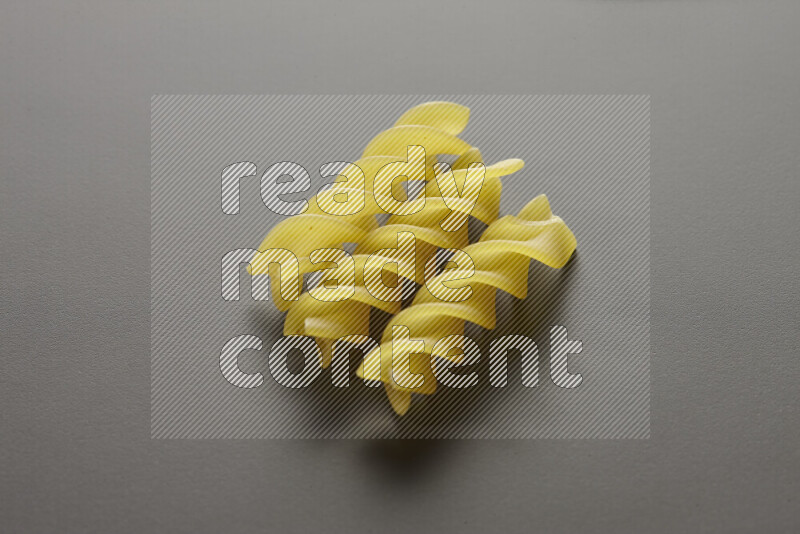 Fusilli pasta on grey background