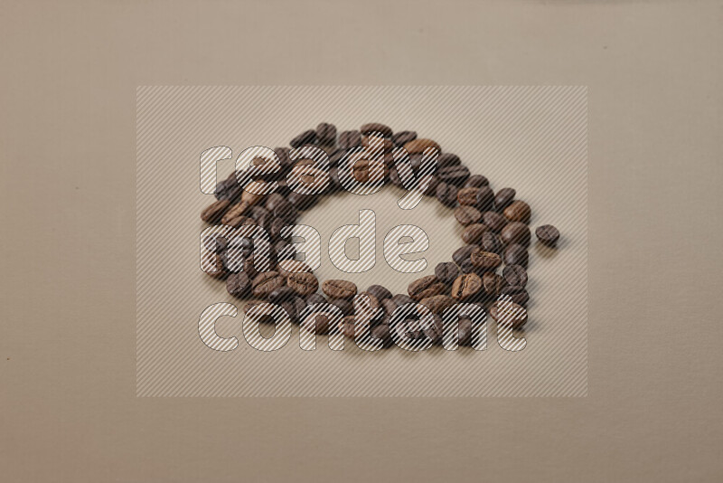 Roasted coffee beans on beige background