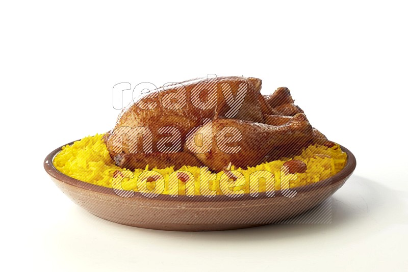 yellow basmati Rice with whole roasted chicken  on a pottery plate  direct  on white background