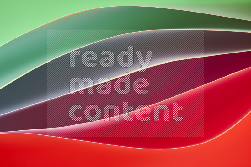 This image showcases an abstract paper art composition with paper curves in green and red gradients created by colored light