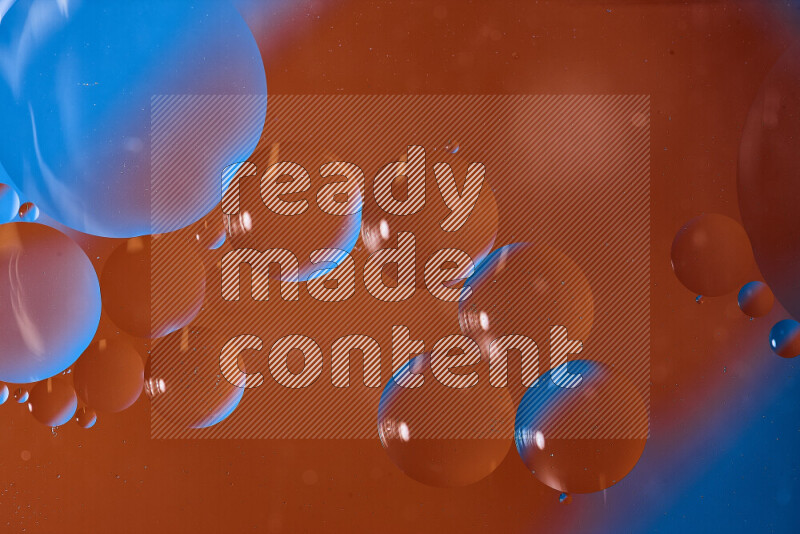 Close-ups of abstract oil bubbles on water surface in shades of blue and orange
