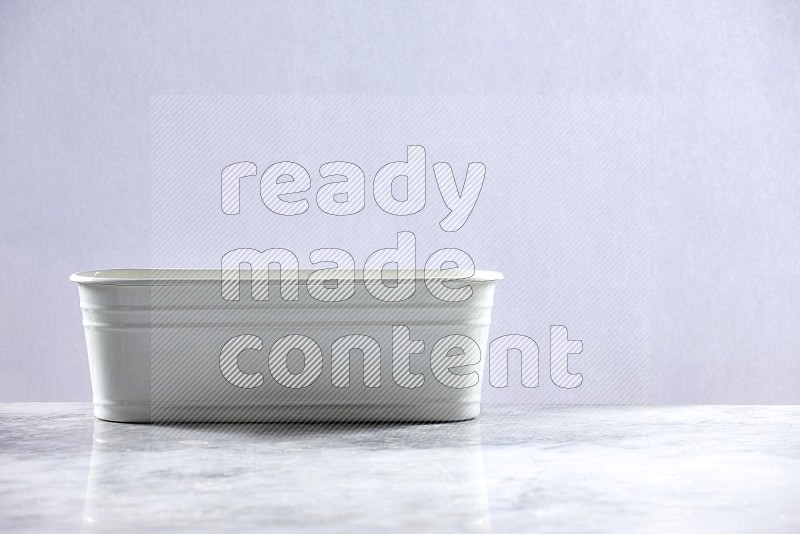 An Empty White Plant Pot on light grey Marble Flooring 15 degree angle