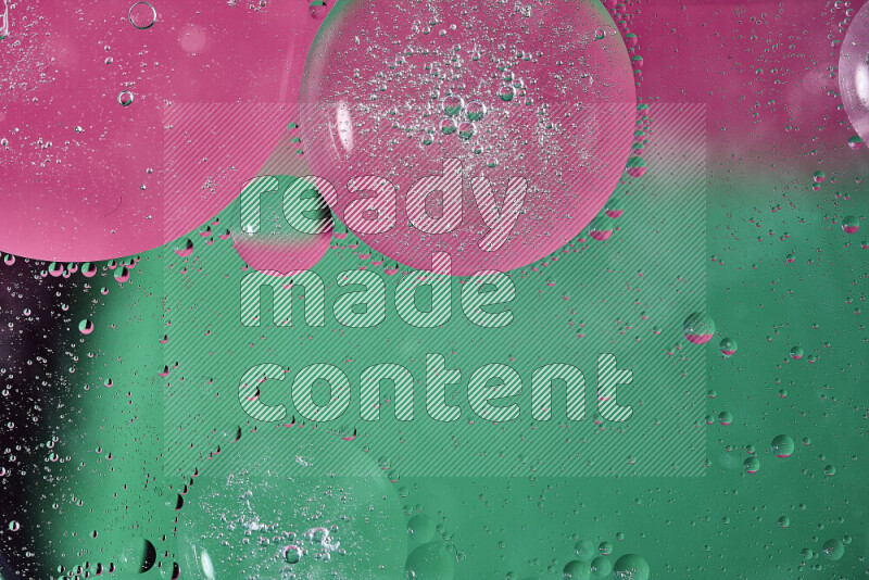 Close-ups of abstract oil bubbles on water surface in shades of green and pink