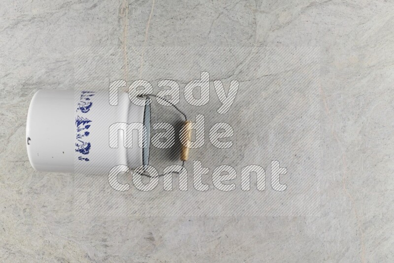 A vintage milk can on grey marble background