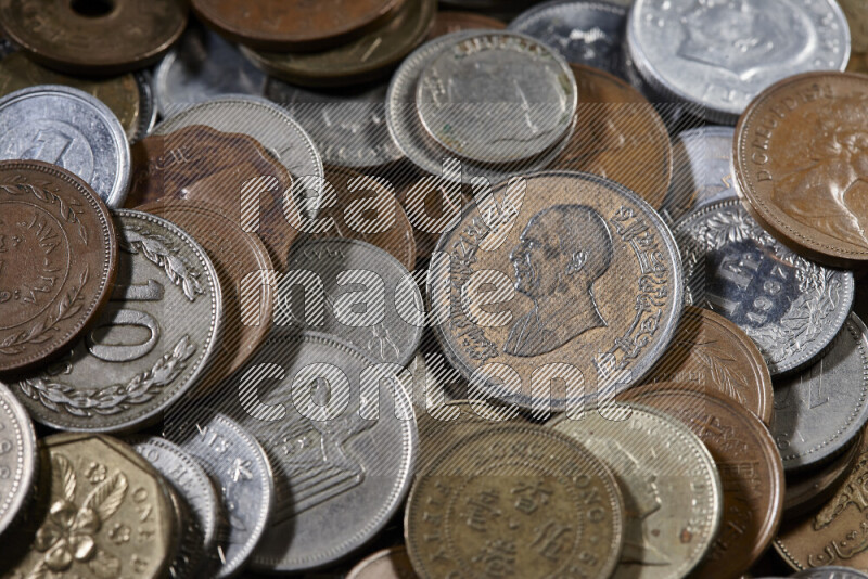 A close-ups of random old coins on black background