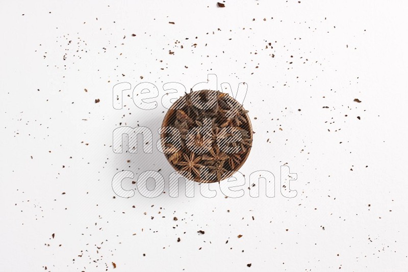 Star Anise in a wooden bowl on white flooring