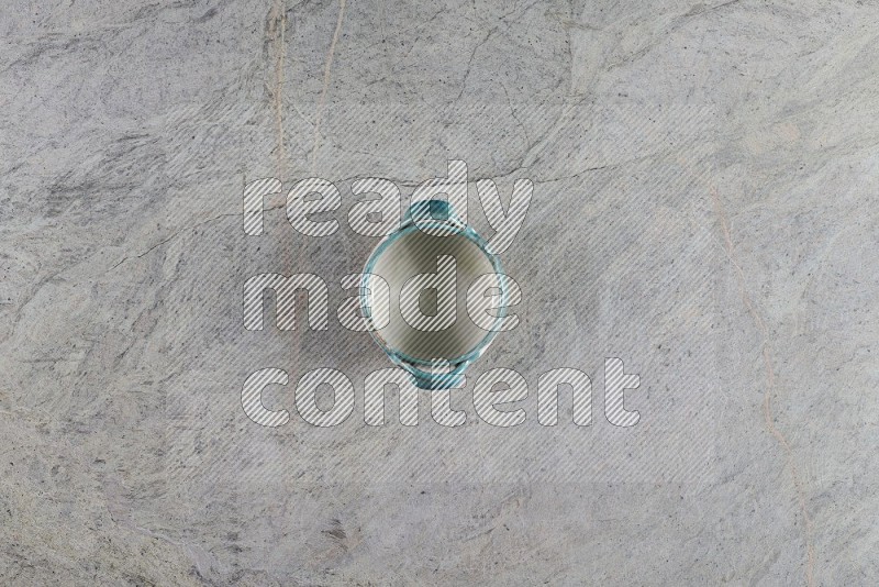 Top View Shot Of A Multicolored Pottery Bowl On Grey Marble Flooring