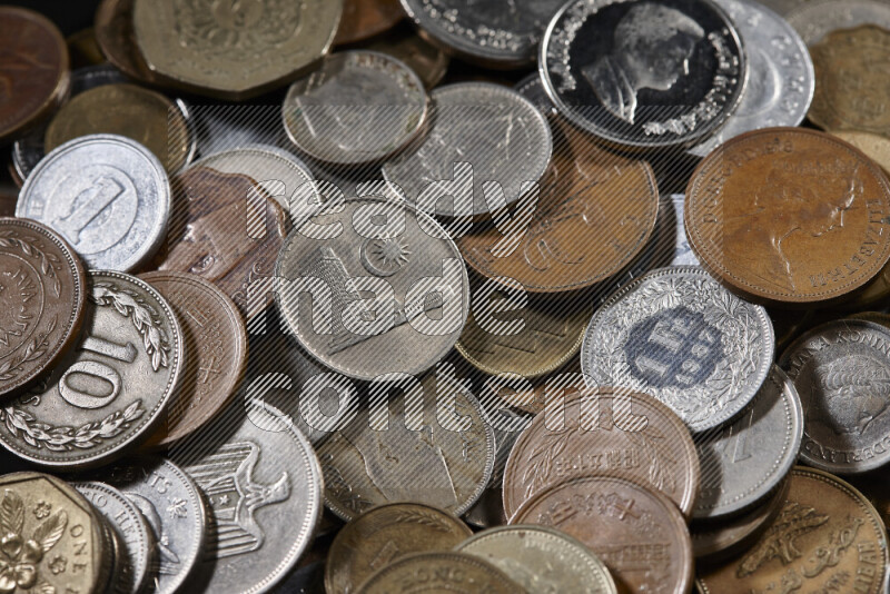 A close-ups of random old coins on black background