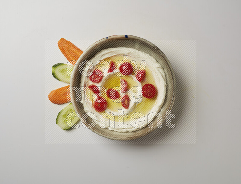 Lebnah garnished with cherry tomato in a grey pottery plate on a white background