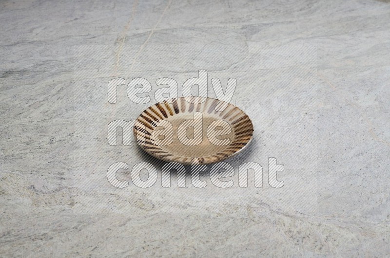 Multicolored Pottery Plate On Grey Marble Flooring