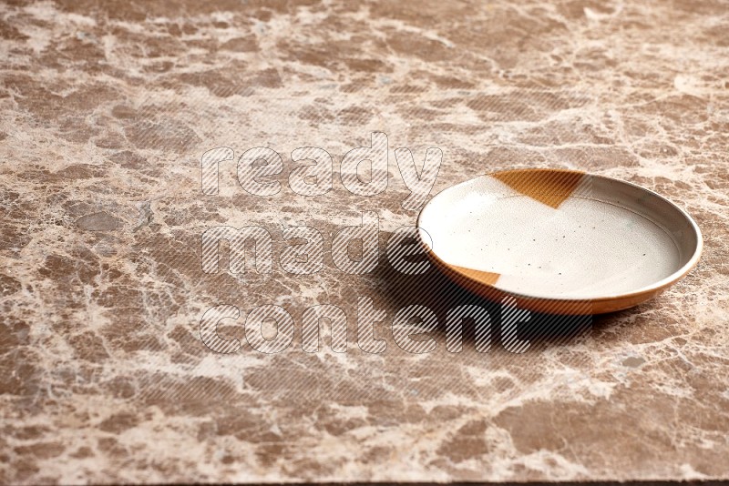 Multicolored Pottery Plate on Beige Marble Flooring, 45 degrees