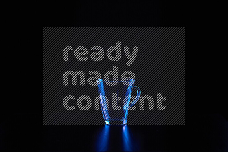 Glassware with rim light in blue against black background