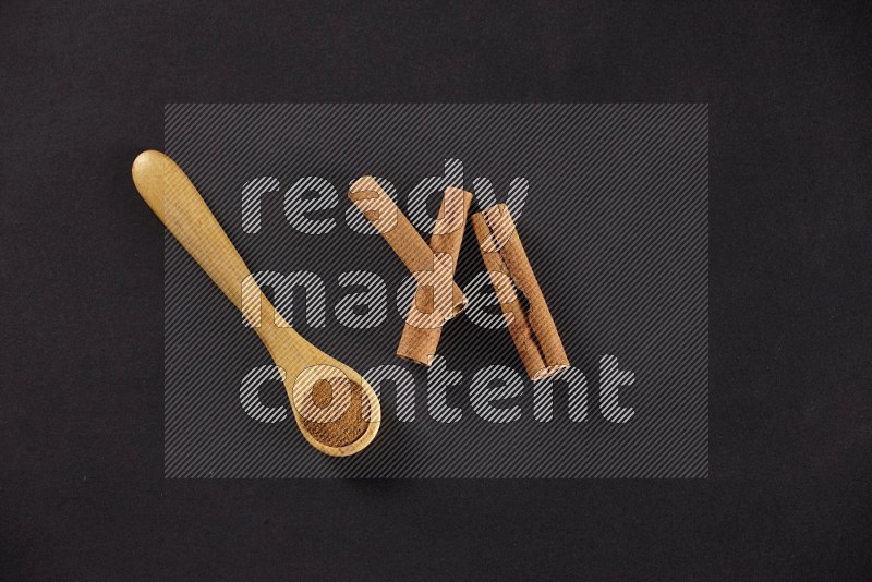 3 Cinnamon sticks stacked beside a wooden spoon full of cinnamon powder on black background in different angles