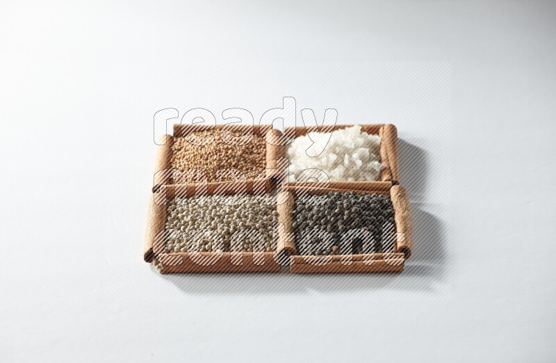 4 squares of cinnamon sticks full of mustard, salt, white pepper and black pepper on white flooring