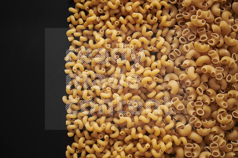 Different pasta types on black background