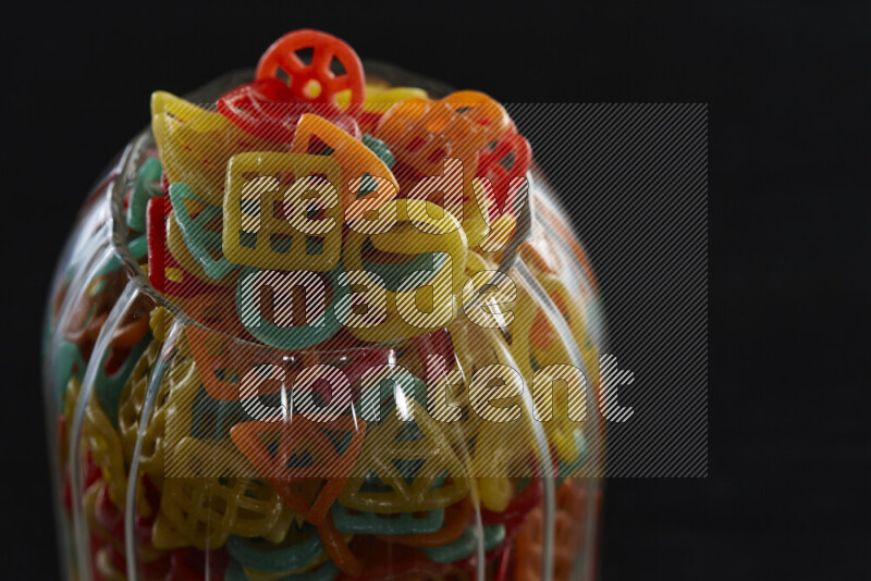 Snacks in a glass jar on black background