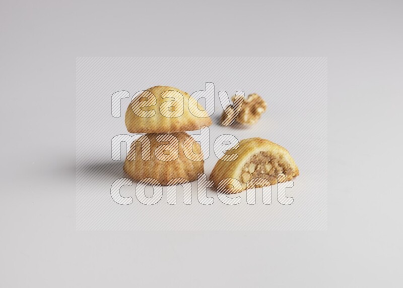 Three Pieces of Maamoul filled with walnut paste  one of them is cut direct on white background