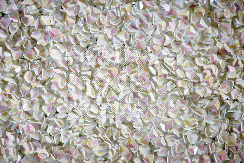 Colorful plastic shards for decoration scattered on a black background