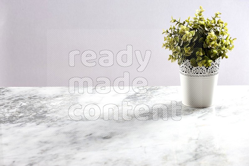 Artificial Plant in White Decorative Pot on Light Grey Marble Background 45 degree angle