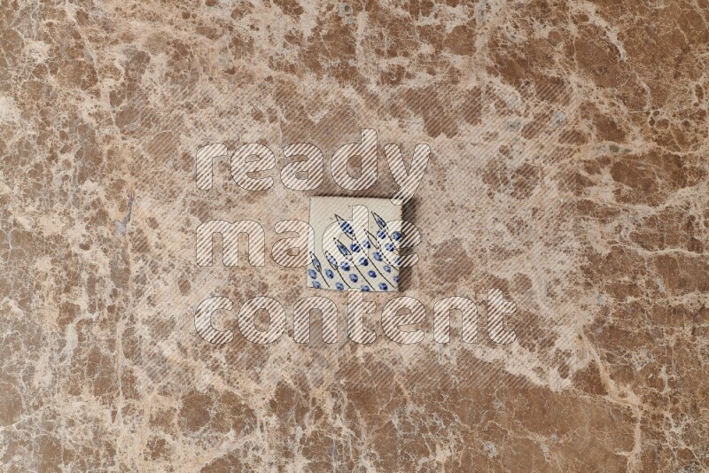 A decorative coaster on beige marble background