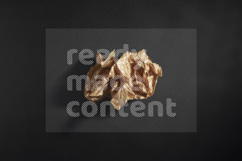 Crumpled craft paper on black background