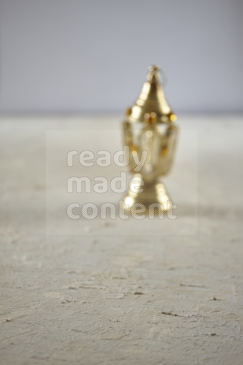 A lantern placed on a textured white background