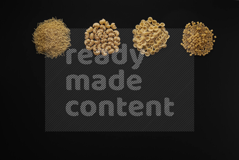 Different pasta types in 4 bunches on black background