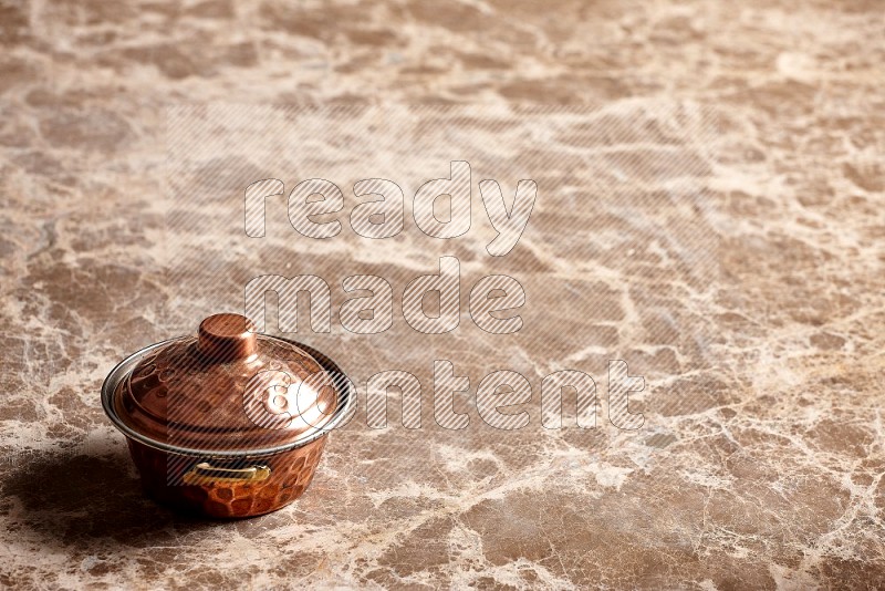 Small Copper Pot on Beige Marble Flooring, 45 degrees