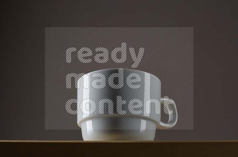 Low angle shot of a white cup on grey background