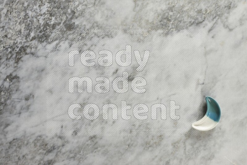 A pottery crescent plate on grey marble background