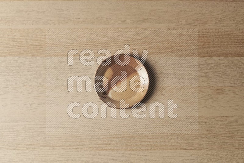 Top View Shot Of A Multicolored Pottery Plate on Oak Wooden Flooring