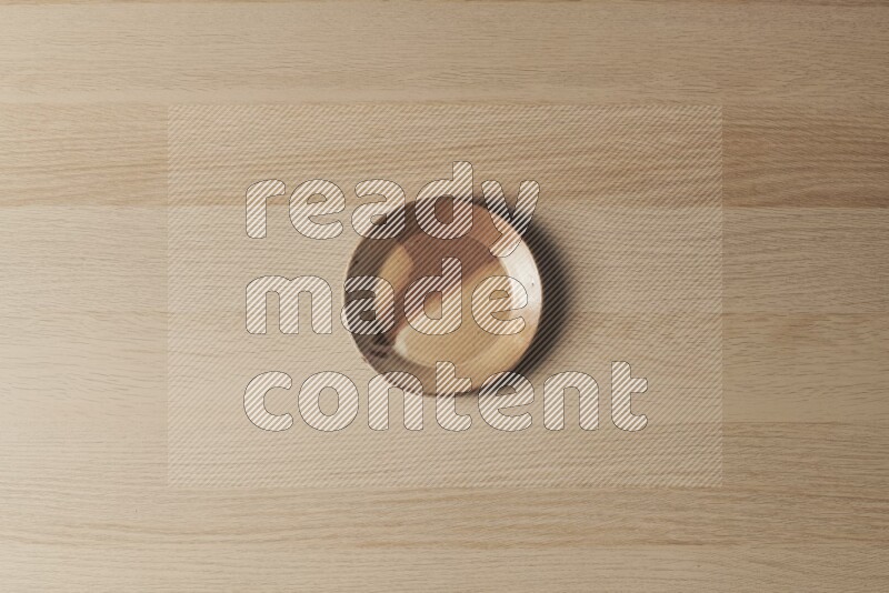 A multicolored pottery plate on light wooden background