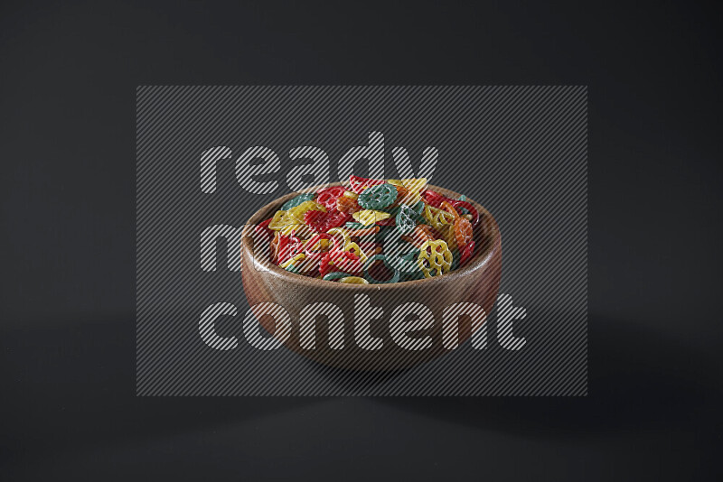 Snacks in a wooden bowl on grey background
