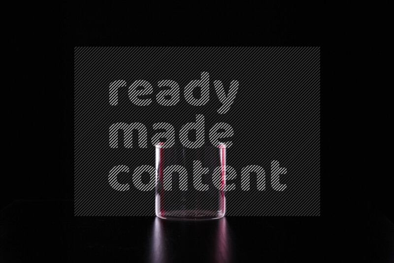 Glassware with rim light in red and white against black background