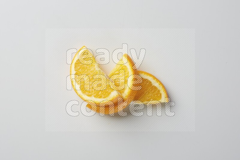 Three halves of an orange slices on white background