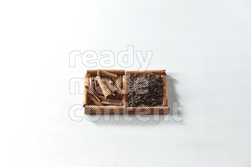 2 squares of cinnamon sticks full of cloves and cinnamon on white flooring