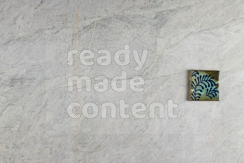 Top View Shot Of A Pottery Coaster tile On Grey Marble Flooring