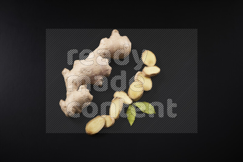 Fresh ginger root on black background