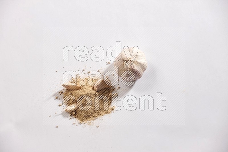 Garlic powder and garlic bulb and cloves on a white flooring in different angles