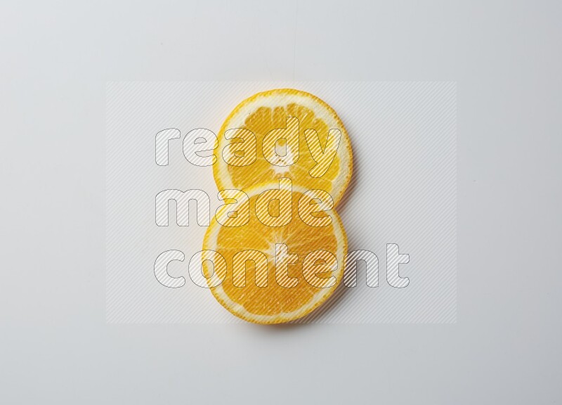 Two orange slices on white background