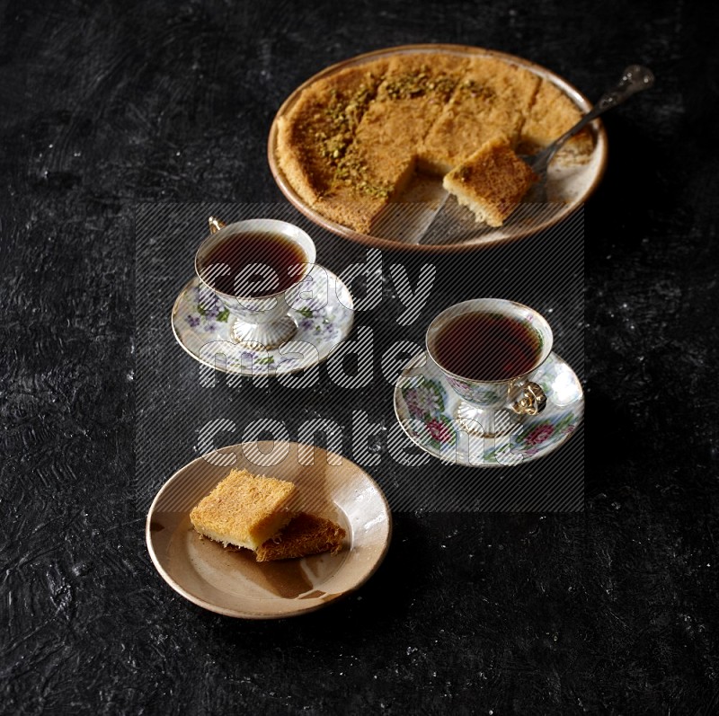 konafa with tea in a dark setup